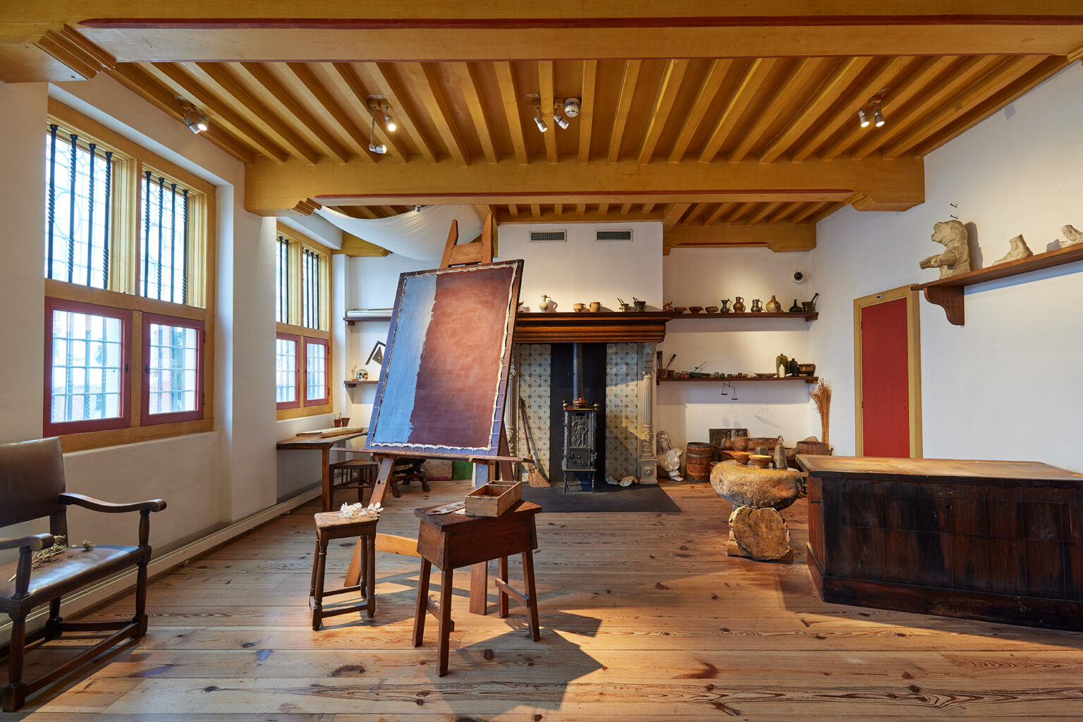The big atelier in which Rembrandt worked, with a painting easel and fireplace